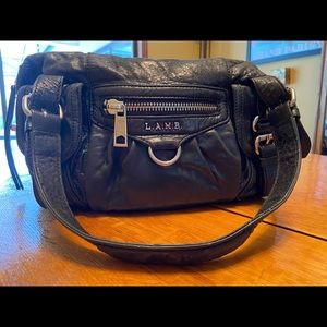 L.A.M.B. by Gwen Stefani.  Black leather satchel.